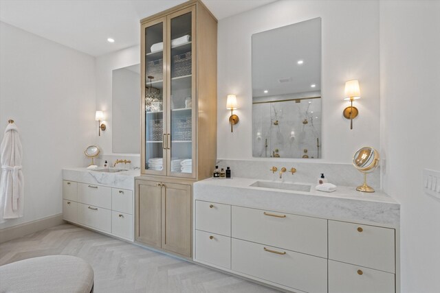bathroom featuring two vanities, a stall shower, and recessed lighting