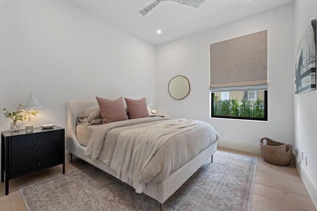 bedroom with recessed lighting, baseboards, and wood finished floors
