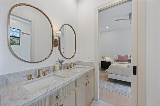 full bathroom featuring double vanity, wood finished floors, and ensuite bath