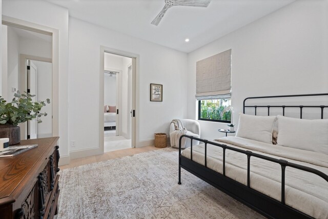 bedroom with light wood-type flooring, connected bathroom, recessed lighting, baseboards, and a ceiling fan