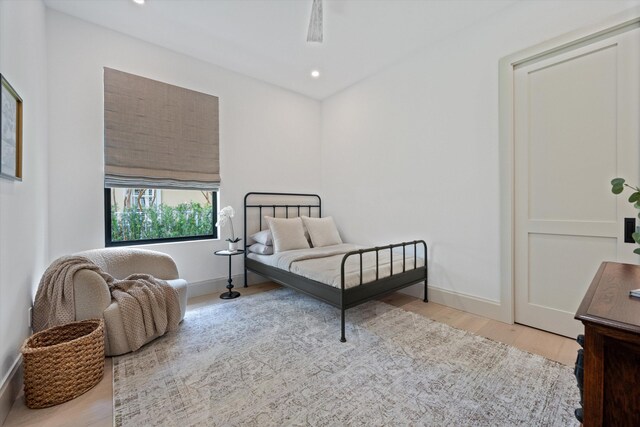 bedroom featuring wood finished floors, baseboards, and recessed lighting