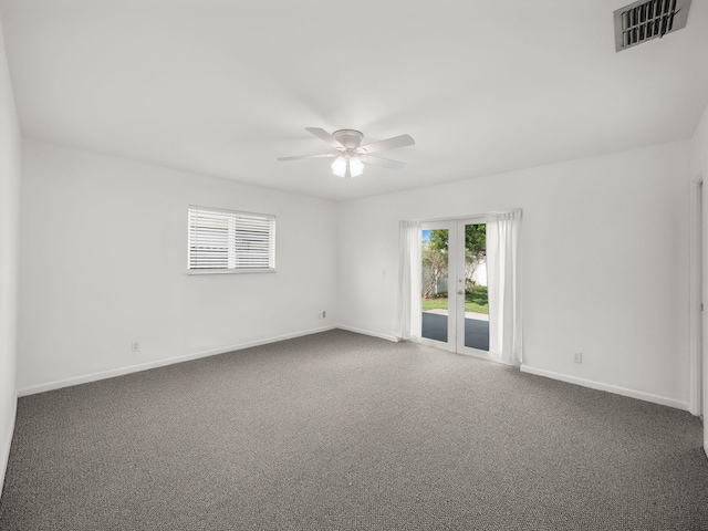 spare room with ceiling fan, baseboards, and carpet