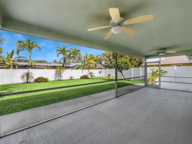 unfurnished sunroom featuring a ceiling fan