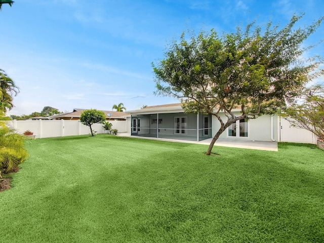 back of property featuring a sunroom and stucco siding