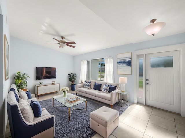 living room featuring a ceiling fan, tile patterned flooring, and lofted ceiling