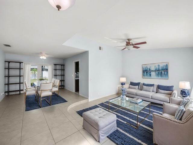 living room with ceiling fan, tile patterned flooring, and baseboards