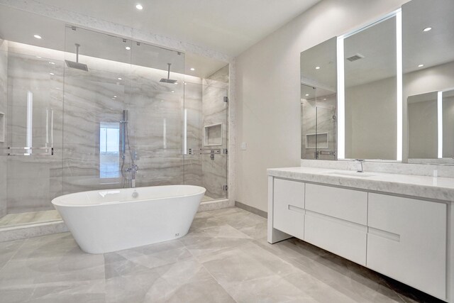 220 SE Mizner Blvd Unit Ph920, Boca Raton, FL 33432 - bathroom with marble tiled flooring, a shower stall, vanity, a freestanding tub, and recessed lighting