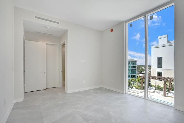 220 SE Mizner Blvd Unit Ph920, Boca Raton, FL 33432 - spare room featuring expansive windows and baseboards