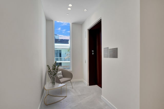 220 SE Mizner Blvd Unit Ph920, Boca Raton, FL 33432 - hallway featuring a wall of windows and baseboards