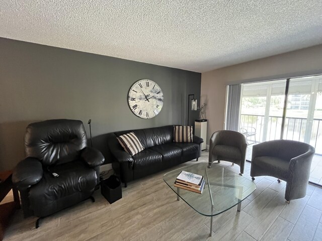 7340 Amberly Ln # 205, Delray Beach, FL 33446 - living room featuring a textured ceiling and wood finished floors