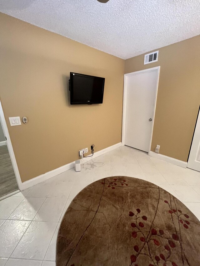 7340 Amberly Ln # 205, Delray Beach, FL 33446 - interior space featuring baseboards, light tile patterned flooring, visible vents, and a textured ceiling