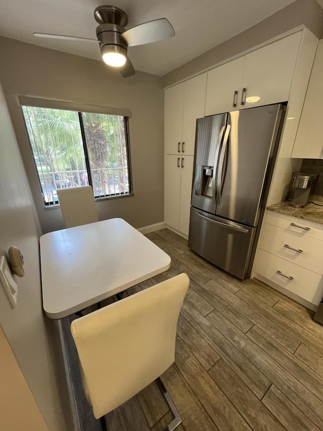 7340 Amberly Ln # 205, Delray Beach, FL 33446 - kitchen with wood finished floors, stainless steel refrigerator with ice dispenser, light countertops, a ceiling fan, and white cabinets