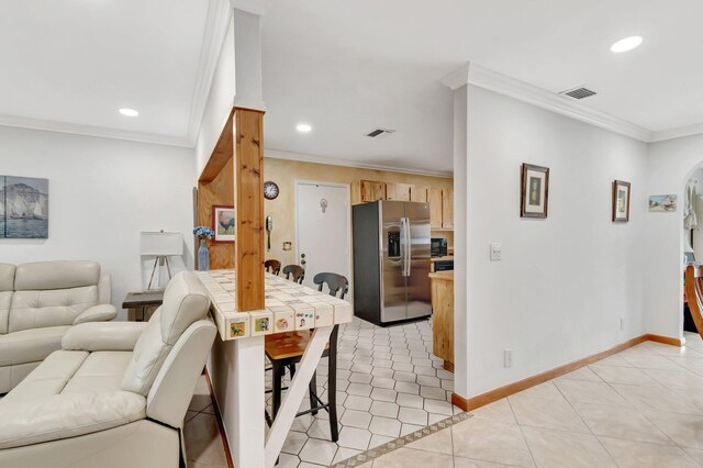 654 Bunting Dr, Delray Beach, FL 33444 - living area with light tile patterned floors, ornamental molding, and visible vents