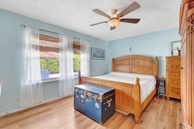 654 Bunting Dr, Delray Beach, FL 33444 - bedroom featuring a ceiling fan, light wood finished floors, and a textured ceiling