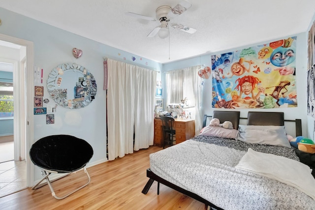 654 Bunting Dr, Delray Beach, FL 33444 - bedroom with baseboards, light wood-style floors, and a ceiling fan