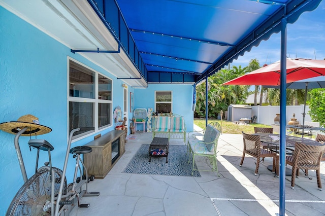 654 Bunting Dr, Delray Beach, FL 33444 - view of patio featuring outdoor dining space, fence, an outdoor living space, and a shed