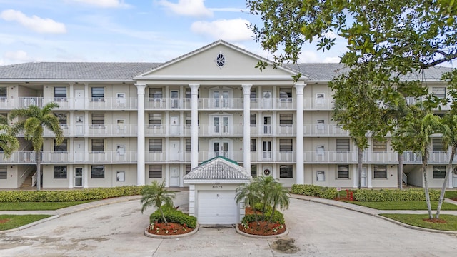 6169 Balboa Cir Unit 101, Boca Raton, FL 33433 - view of property featuring driveway and a garage