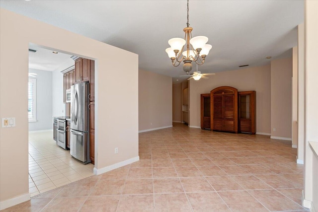 4922 SE Heartleaf Ter, Hobe Sound, FL 33455 - empty room with a chandelier, light tile patterned floors, ceiling fan, and baseboards