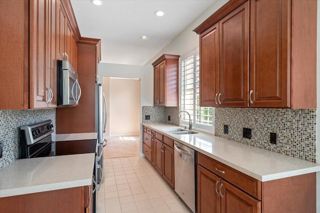 4922 SE Heartleaf Ter, Hobe Sound, FL 33455 - kitchen featuring appliances with stainless steel finishes, a sink, decorative backsplash, light tile patterned flooring, and light countertops