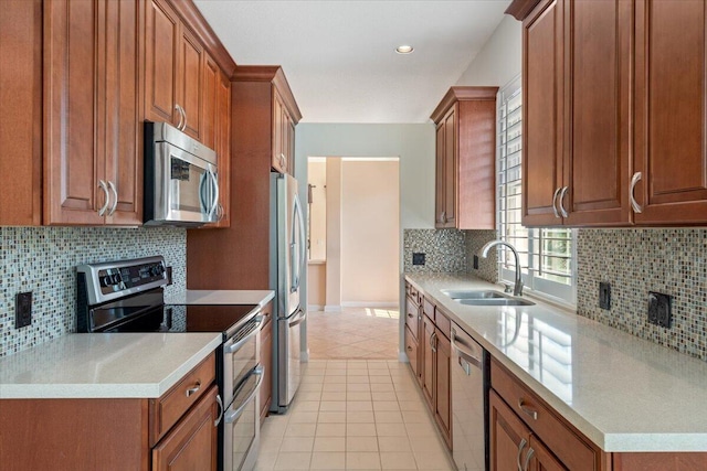 4922 SE Heartleaf Ter, Hobe Sound, FL 33455 - kitchen featuring stainless steel appliances, a sink, brown cabinets, backsplash, and recessed lighting