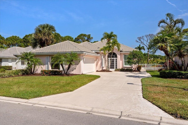 4922 SE Heartleaf Ter, Hobe Sound, FL 33455 - single story home featuring an attached garage, stucco siding, concrete driveway, and a tiled roof
