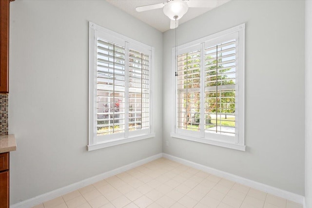 4922 SE Heartleaf Ter, Hobe Sound, FL 33455 - unfurnished dining area featuring ceiling fan, baseboards, and tile patterned floors
