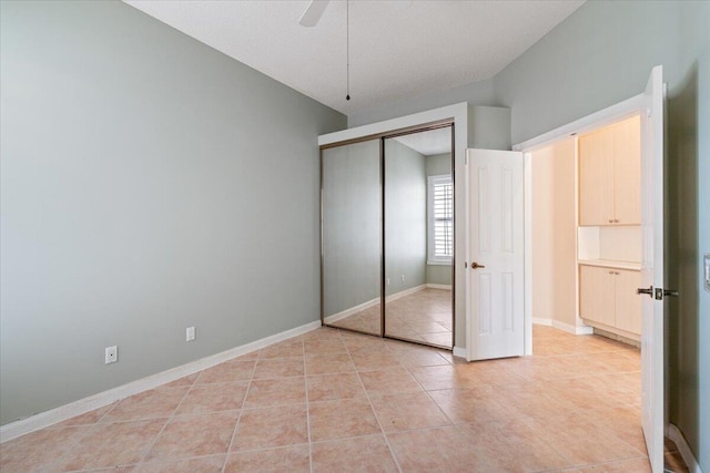 4922 SE Heartleaf Ter, Hobe Sound, FL 33455 - unfurnished bedroom with light tile patterned floors, a closet, baseboards, and a ceiling fan