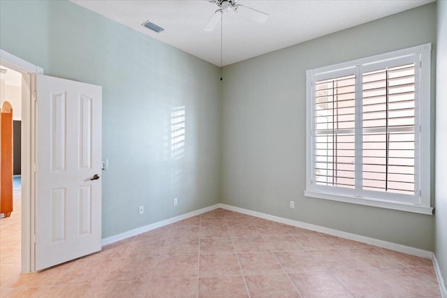 4922 SE Heartleaf Ter, Hobe Sound, FL 33455 - spare room with ceiling fan, plenty of natural light, light tile patterned floors, and baseboards