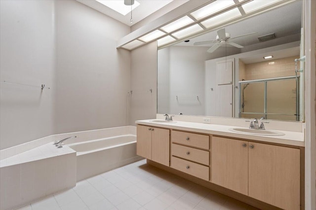 4922 SE Heartleaf Ter, Hobe Sound, FL 33455 - bathroom featuring a stall shower, a garden tub, double vanity, a ceiling fan, and tile patterned floors