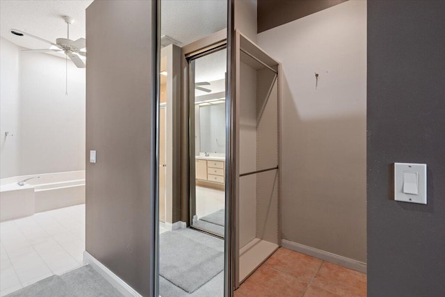 4922 SE Heartleaf Ter, Hobe Sound, FL 33455 - spacious closet with a ceiling fan and light tile patterned floors