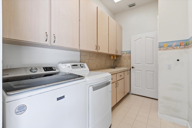 4922 SE Heartleaf Ter, Hobe Sound, FL 33455 - laundry room featuring washing machine and clothes dryer, light tile patterned floors, and cabinet space