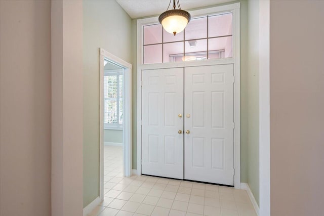 4922 SE Heartleaf Ter, Hobe Sound, FL 33455 - entrance foyer featuring baseboards and light tile patterned floors
