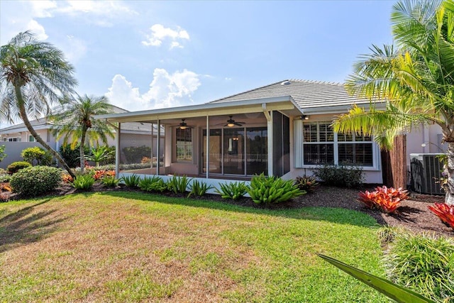 4922 SE Heartleaf Ter, Hobe Sound, FL 33455 - rear view of property with a ceiling fan, a sunroom, cooling unit, and a yard