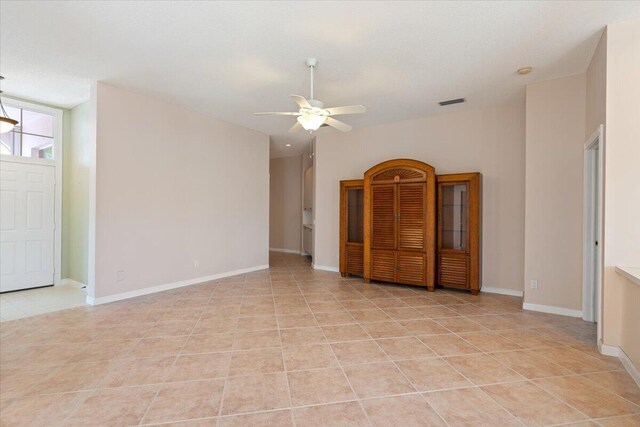 4922 SE Heartleaf Ter, Hobe Sound, FL 33455 - spare room featuring ceiling fan, light tile patterned floors, and baseboards