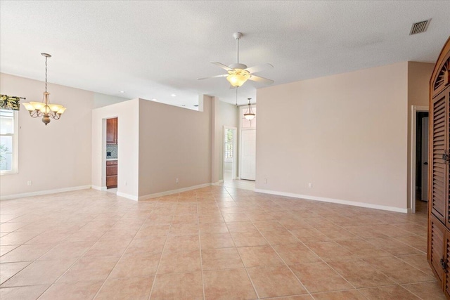4922 SE Heartleaf Ter, Hobe Sound, FL 33455 - spare room featuring a chandelier, light tile patterned floors, a ceiling fan, and baseboards