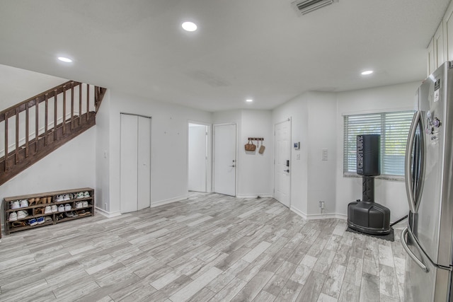 foyer with light wood-style floors, visible vents, stairway, and recessed lighting