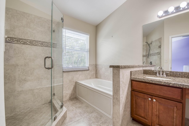 full bath featuring a bath, vanity, tile patterned flooring, and a stall shower