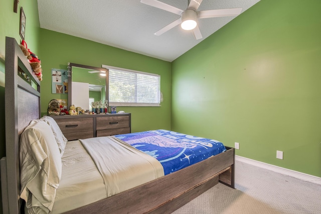 carpeted bedroom with baseboards, ceiling fan, and vaulted ceiling