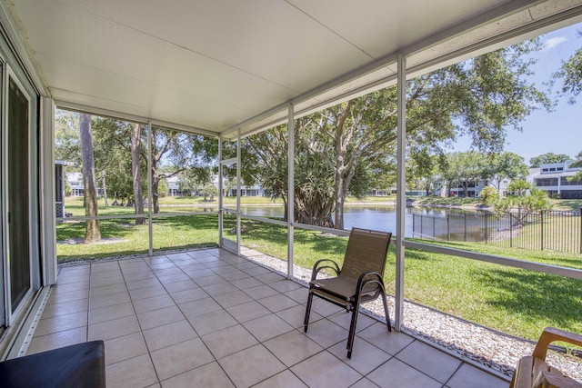 unfurnished sunroom featuring a water view