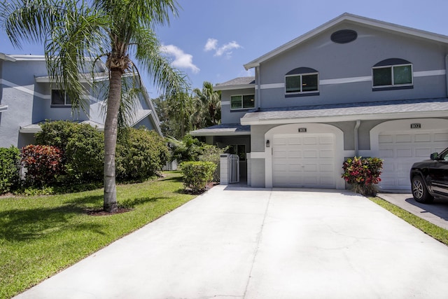 view of front of house with driveway, a garage, stucco siding, a front lawn, and cooling unit