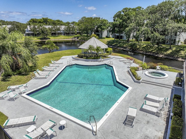 pool with a patio area, a water view, and a gazebo