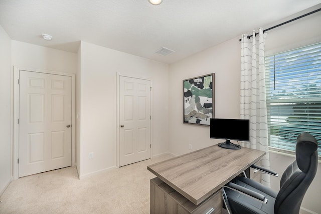 office space with light colored carpet, baseboards, and visible vents