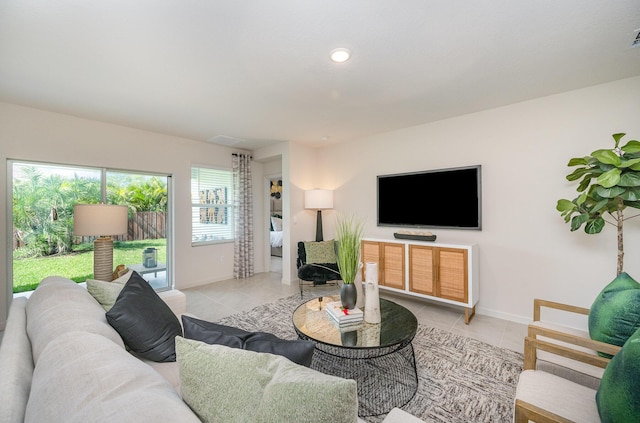 living room with baseboards, light tile patterned floors, and recessed lighting