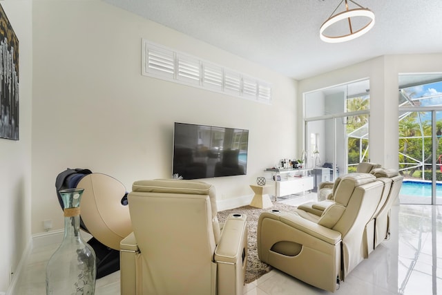 living room featuring baseboards and a textured ceiling