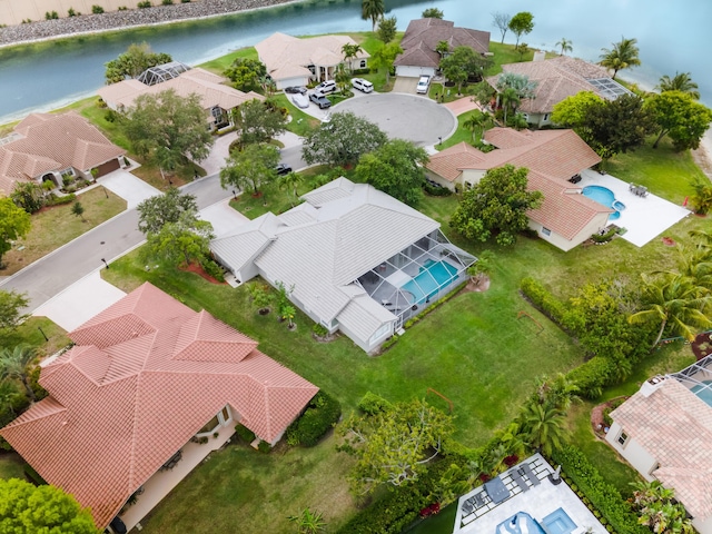 drone / aerial view with a water view and a residential view
