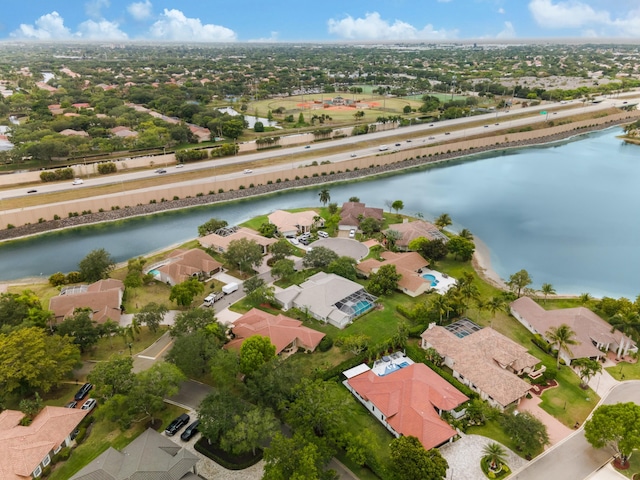 birds eye view of property with a water view and a residential view