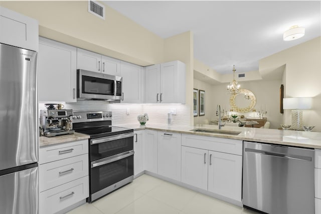 250 NE 3rd Ave Unit 1308, Delray Beach, FL 33444 - kitchen with a sink, visible vents, appliances with stainless steel finishes, a chandelier, and tasteful backsplash