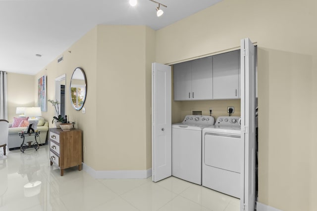 250 NE 3rd Ave Unit 1308, Delray Beach, FL 33444 - laundry area with washing machine and clothes dryer, light tile patterned flooring, cabinet space, and visible vents