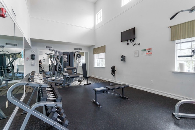 250 NE 3rd Ave Unit 1308, Delray Beach, FL 33444 - gym featuring plenty of natural light, a towering ceiling, and baseboards