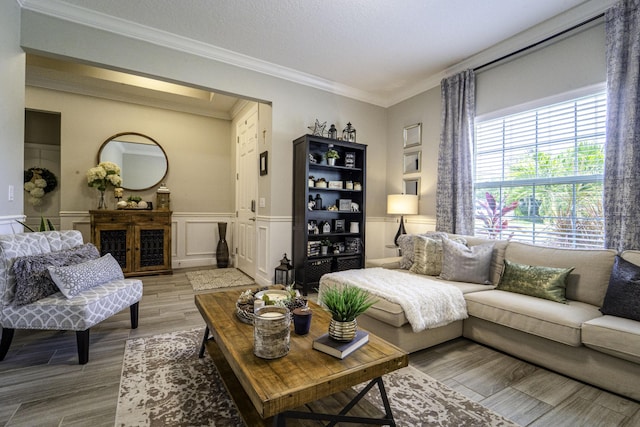6920 NW Jorgensen Rd, Port Saint Lucie, FL 34983 - living room with light wood-style flooring, ornamental molding, a wainscoted wall, and a decorative wall